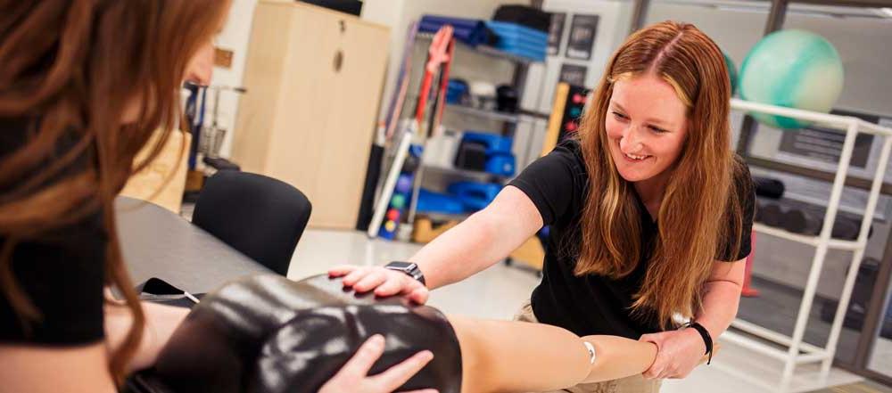 students practice on a lab arm